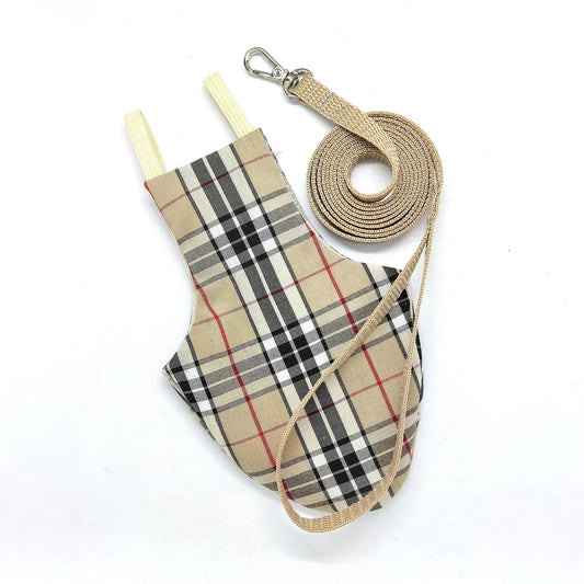 Beige plaid-patterned pigeon pants or bird diaper with a matching leash on a white background
