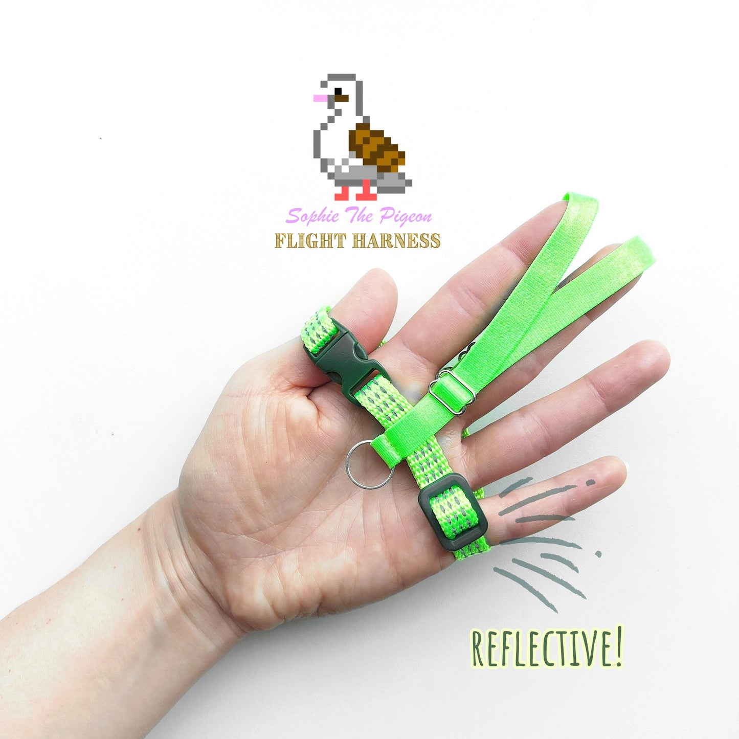 Green reflective flight harness for pigeons held in a hand on a white background